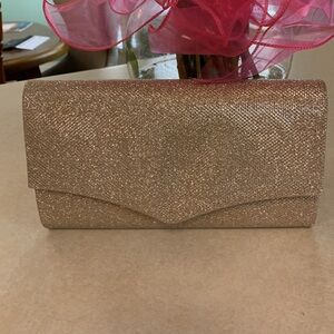 Gold shimmery purse! Like new!! Used only one time by mother of the bride.